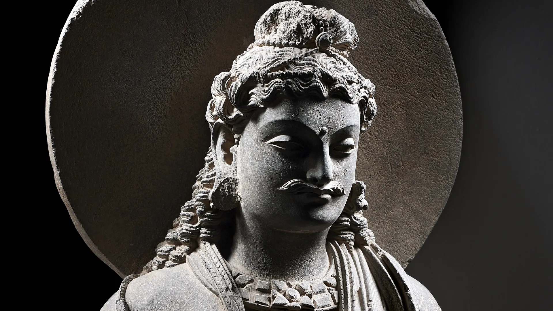 A grey schist figure of Maitreya