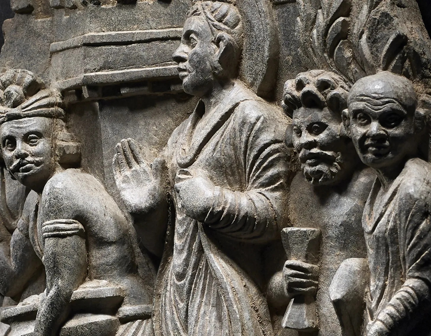 Close up look of : A grey schist panel depicting Buddha and attendants