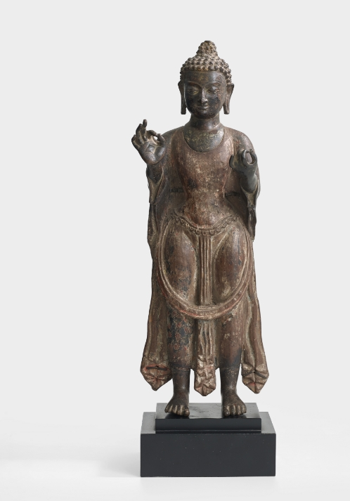 A copper and wood figure of Dipankara Buddha