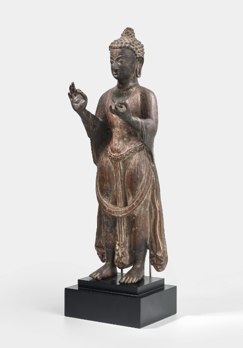 A copper and wood figure of Dipankara Buddha