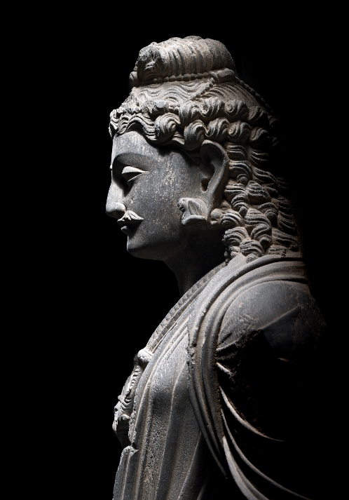 A grey schist figure of Maitreya
