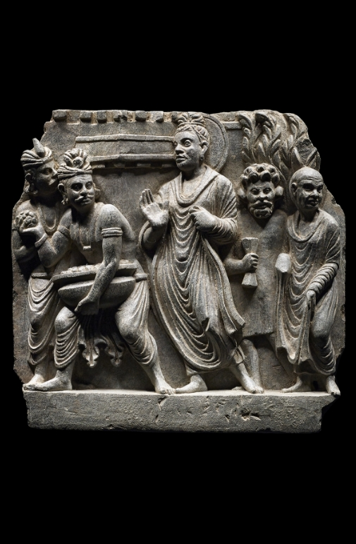 A grey schist panel depicting Buddha and attendants